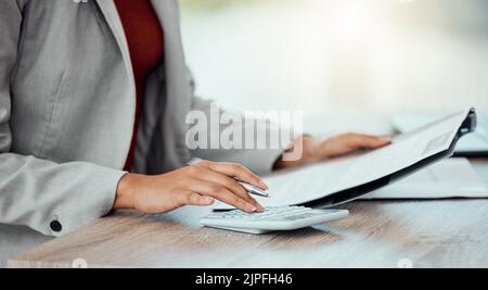 Closeup of auditor, banker and business accountant womans hand calculating, planning and doing financial paperwork. A businesswoman managing Stock Photo