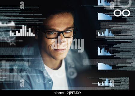 Determined to crack this code before the deadline. a young computer programmer looking through data in the dark. Stock Photo