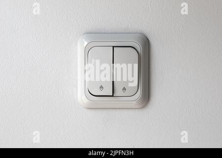 Light switch panel, white color on white wall, front view Stock Photo