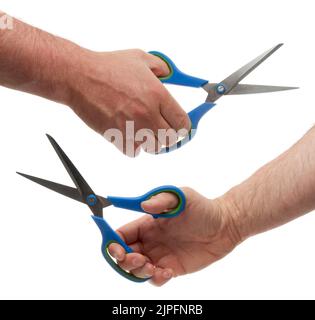 Hand with metal scissors with blue plastic handles. Isolated on white background with clipping path Stock Photo