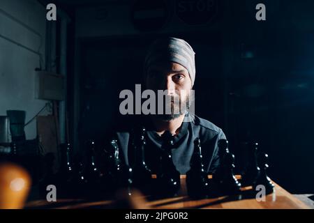 Male chess player with figures in the eyes, thinking process