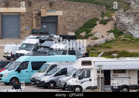 Campervans parked at Little Fistral in Newquay in Cornwall in the UK. Stock Photo