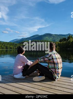 Dutch Lake on an Autumn Morning, Clearwater, British Columbia Canada in BC. couple of men and women on a wooden pier by the lake in Canada BC Stock Photo