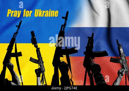 Two enemy flags and combat military assault rifles AK 74 and AK 74U on their background, Russian-Ukrainian war and Russian aggression Stock Photo