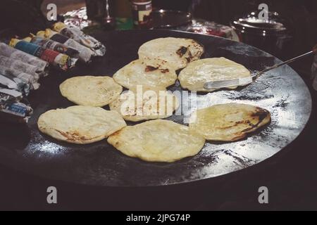 India pancake Roti cooking. cakes fried on a large baking sheet. Paratha Stock Photo