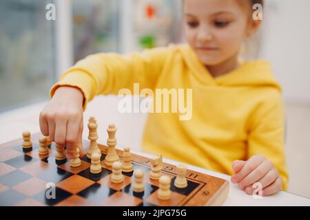 Little kids playing chess at kindergarten or elementary school. Stock Photo
