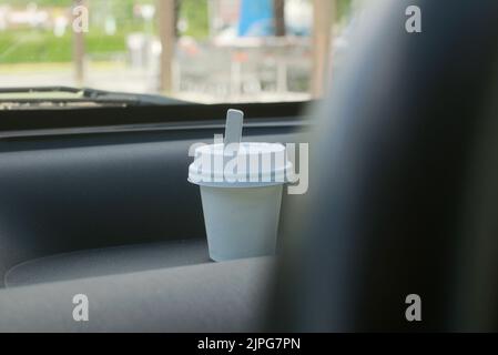 disposable  cup of espresso coffee with lid inside a car Stock Photo