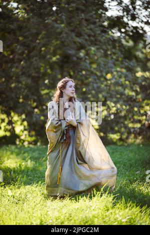 Portrait of a beautiful mature woman dressed in a nymph-style dress inspired by early 20th century artists. Stock Photo