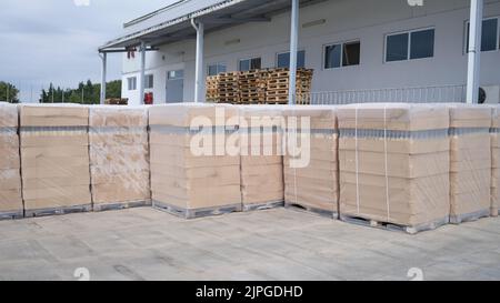 Rows of boxes and pallets in warehouse and production warehouse Stock Photo
