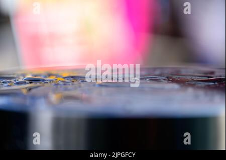 Abstract shallow focus close up shot of water drops reflecting colorful background Stock Photo