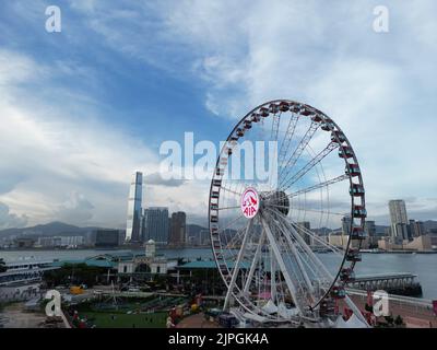 The view of the Ferris wheel in Hong Kong Victoria harbour under the blue cloudy sky Stock Photo