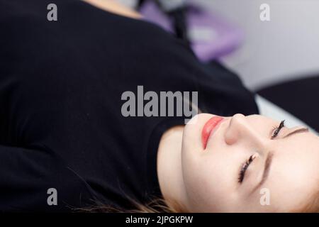 Woman portrait with drawing contour on lips microblading tattoo procedure. Stock Photo