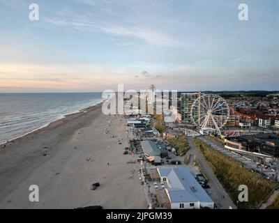 A bird's eye view of buildings and a Ferris wheel on Zandvoort beach, the Netherlands at sunset Stock Photo