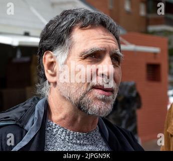 Adult man with white beard and gray hair looking to the horizon Stock Photo