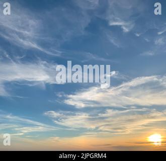 Beautiful sunset sky with some clouds during summer on a nice day Stock Photo