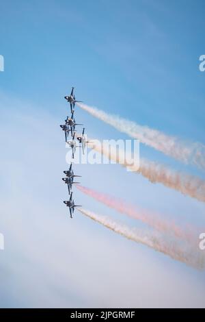 Eight Korean Air Force Golden Eagle Military Jet Trainers of the Black Eagles display team fly in extremely close formation while making a turn Stock Photo