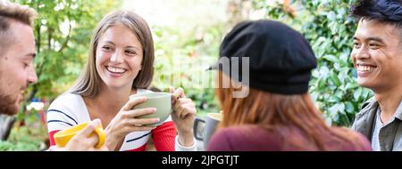 Horizontal banner or header with young people drinking cappuccino and espresso coffee at cafe bar garden - Happy friends talking and having fun togeth Stock Photo