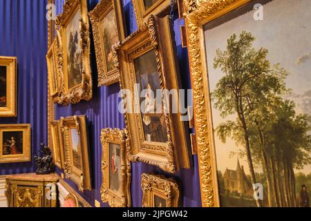 Side detail of Old Mater paintings hanging on the wall, including a work by Gerard ter Borch. At the Wallace Collection Museum in London, England, Uni Stock Photo