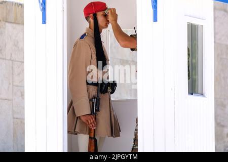 A soldier wipes sweat from the face of a presidential guard at the Tomb of the Unknown Soldier outside the Greek Parliament during a hot day in Athens, Greece on August 18, 2022. Credit: ALEXANDROS MICHAILIDIS/Alamy Live News Stock Photo
