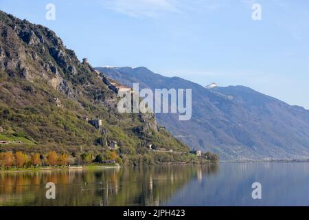 Lake Idro, Italy - April 18, 2018: Looking towards the west shore of Lake Idro in northern Italy, in the distance a snowy mountain peak. High above th Stock Photo