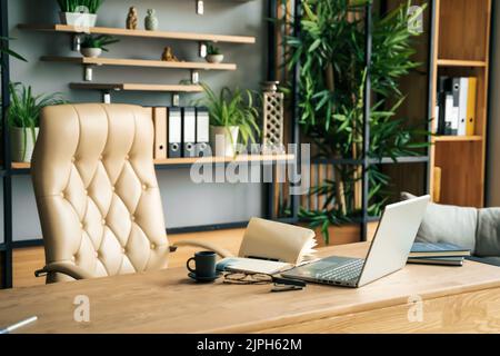 Modern office of general manager, businessman, ceo. Stylish wooden table, leather chair, interior. Workplace, workspace of accountant, financial direc Stock Photo