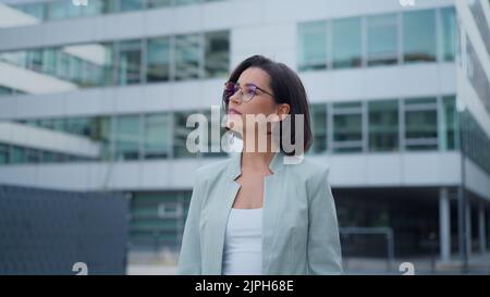 Happy woman smiling while using smartphone, writing text message, check social media and work emails Stock Photo