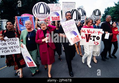 The Rev. Jesse Jackson, of the Rainbow Coalition, center, Jill Ireland of NOW, right, and Eleanor Smeal of the Feminist Majority, left, lead a protest rally against the Republican welfare reform plan outside the White House, August 1, 1996 in Washington, D.C. Stock Photo