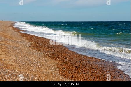 A view of the shingle beach and sea in summer on the North Norfolk coast towards Blakeney Point from Cley-Next-the-Sea, Norfolk, England, UK. Stock Photo