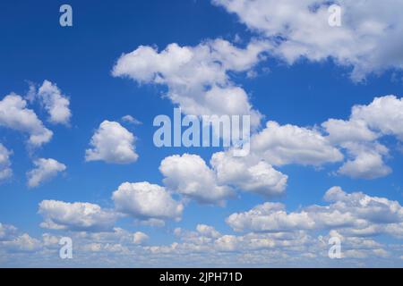 Fluffy clouds on blue sky in summer Stock Photo