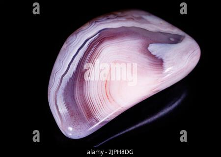 Macro mineral stone Agate pink Persian on a black background close up Stock Photo