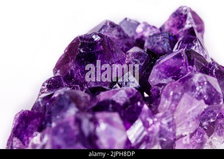 Macro mineral stone purple amethyst in crystals on a white background close up Stock Photo