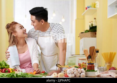 Happy young couple in love in their bright kitchen Stock Photo