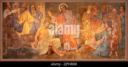 BERN, SWITZERLAND - JUNY 27, 2022: The fresco of Christ at the healing in the church Dreifaltigkeitskirche by August Müller (1923). Stock Photo