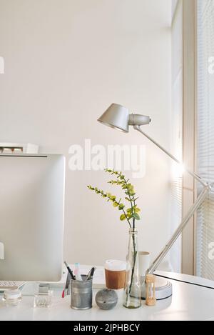 Lamp, computer and office supplies on table Stock Photo