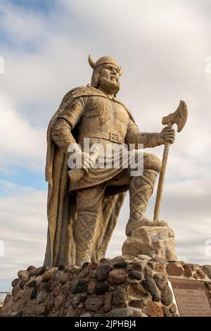 Vertical view of old Viking statue on waterfront of lake Winnipeg in Gimli, Manitoba, Canada under cloudy sky Stock Photo