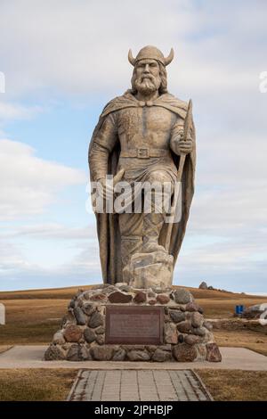 Vertical view of old Viking statue on waterfront of lake Winnipeg in Gimli, Manitoba, Canada under cloudy sky Stock Photo