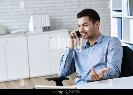 Portrait of handsome young businessman talking on the phone Stock Photo