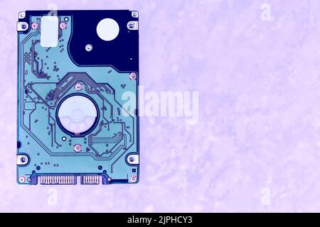 Internal hard drive for storing information on a lilac purple sandy surface Stock Photo