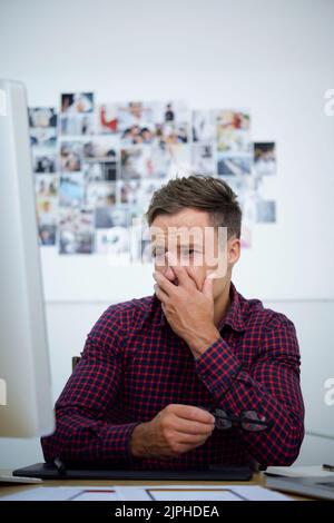 Crying frustrated man reading e-mail on computer Stock Photo