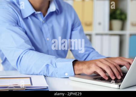 Cropped image of businessman working on laptop Stock Photo
