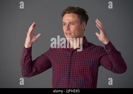 Handsome young man does not understand anything Stock Photo