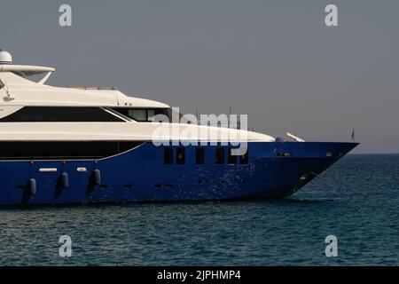 Ios, Greece - June 7, 2021 : Closeup view of a beautiful yacht at the Manganari beach of Ios Greece Stock Photo