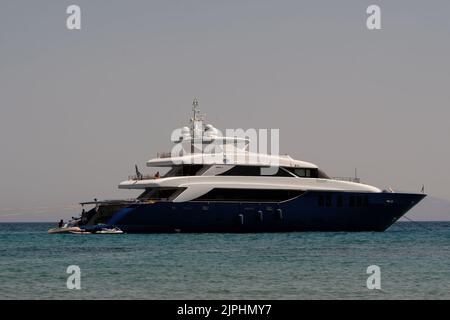 Ios, Greece - June 7, 2021 : Closeup view of a beautiful yacht at the Manganari beach of Ios Greece Stock Photo