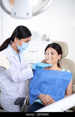 Asian female dentist working on teenage patient Stock Photo