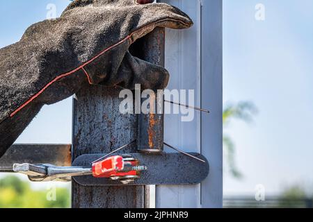 A worker installs a metal profile. Stock Photo