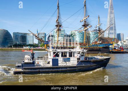 Gotheborg of Sweden, sailing replica of the Swedish East Indiaman Gotheborg I, visiting London. City skyline. Port of London Authority Harbour Master Stock Photo