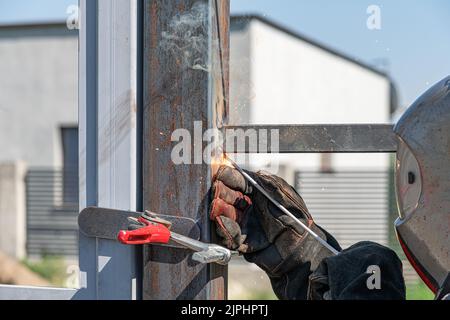 A worker installs a metal profile. Stock Photo