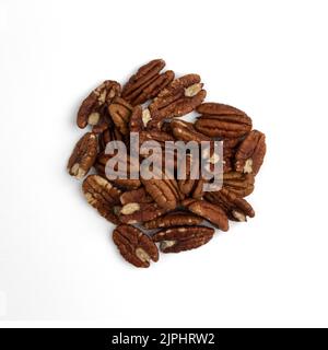 heap of peeled pecan nuts isolated on white background, top view, healthy snack Stock Photo