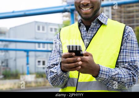 Builder Worker Using Phone. Construction Employee Communication Stock Photo