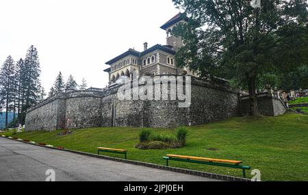 The beautiful Cantacuzino Castle in Busteni, Romania surrounded by green area and trees Stock Photo